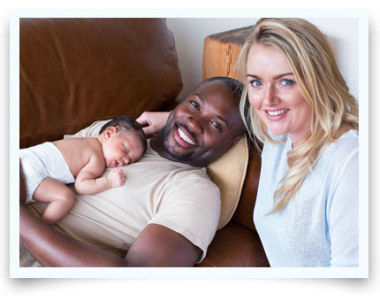 couple with baby laying on husbands chest